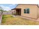 This backyard features a covered patio with a swing, a grassy area, and a privacy fence at 7216 N 124Th Ln, Glendale, AZ 85307