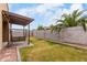 This backyard features a covered patio with a swing and a large grassy area at 7216 N 124Th Ln, Glendale, AZ 85307
