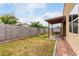 The backyard features a pergola swing and a block wall for privacy at 7216 N 124Th Ln, Glendale, AZ 85307
