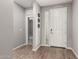 Inviting entryway featuring wood-look flooring, neutral paint, and ample natural light at 7216 N 124Th Ln, Glendale, AZ 85307