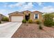 Charming single-story home featuring desert landscaping, a two-car garage, and a welcoming front entrance at 7216 N 124Th Ln, Glendale, AZ 85307