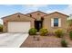 Charming single-story home featuring desert landscaping, a two-car garage, and a welcoming front entrance at 7216 N 124Th Ln, Glendale, AZ 85307