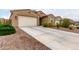 Single-story home featuring desert landscaping, a two-car garage, and extended driveway at 7216 N 124Th Ln, Glendale, AZ 85307