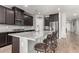 Spacious kitchen features granite counters, stainless appliances, and a breakfast bar with seating for four at 7216 N 124Th Ln, Glendale, AZ 85307