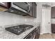 Close up of the kitchen with stainless steel gas range and granite counters at 7216 N 124Th Ln, Glendale, AZ 85307