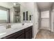 The main bathroom features double sinks, wood look flooring and a glass shower at 7216 N 124Th Ln, Glendale, AZ 85307