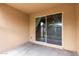 Covered patio space with textured walls and a view of the outdoors through sliding glass doors at 7216 N 124Th Ln, Glendale, AZ 85307