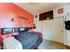 The primary bedroom features bright red walls and a mounted TV at 7815 S 22Nd Ln, Phoenix, AZ 85041