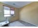 This is a bedroom with a window and carpeted flooring at 7815 S 22Nd Ln, Phoenix, AZ 85041