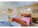 Comfortable bedroom featuring a large bed, bright windows, and an attached bathroom at 7815 S 22Nd Ln, Phoenix, AZ 85041