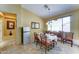 Bright dining area featuring a table with seating for six and carpeted flooring at 7815 S 22Nd Ln, Phoenix, AZ 85041