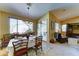 Dining area with view to living room and sliding glass doors to the outdoor space at 7815 S 22Nd Ln, Phoenix, AZ 85041