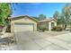 Well-maintained single-story home with a large driveway and terra cotta roof at 7815 S 22Nd Ln, Phoenix, AZ 85041