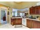 Kitchen view, including an open layout, wood cabinets, white appliances, and sink at 7815 S 22Nd Ln, Phoenix, AZ 85041