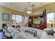 Spacious living room featuring a large entertainment center, comfortable sofas, and large window at 7815 S 22Nd Ln, Phoenix, AZ 85041