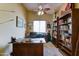 Dedicated office space with custom built-in bookshelves and a spacious wooden desk at 7815 S 22Nd Ln, Phoenix, AZ 85041