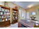 Home office featuring built-in bookcases, a large desk, and natural light, perfect for productivity at 7815 S 22Nd Ln, Phoenix, AZ 85041