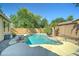 Backyard pool featuring mature trees and lush landscaping at 7815 S 22Nd Ln, Phoenix, AZ 85041