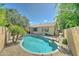 Backyard swimming pool surrounded by desert landscaping and palm tree at 7815 S 22Nd Ln, Phoenix, AZ 85041