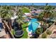 Aerial view of the home's backyard featuring a refreshing blue pool, outdoor seating, and mountain views at 8307 E Buena Terra Way, Scottsdale, AZ 85250