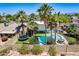 View of backyard showcasing an in-ground pool, hot tub, and trampoline, surrounded by palm trees at 8307 E Buena Terra Way, Scottsdale, AZ 85250