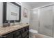 Well-lit bathroom featuring a shower and a vanity with a granite countertop at 8307 E Buena Terra Way, Scottsdale, AZ 85250
