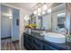 Bright bathroom featuring a vessel sink, granite countertop, and stylish decorative lighting at 8307 E Buena Terra Way, Scottsdale, AZ 85250