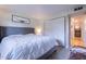 Cozy bedroom with a large bed, closet space, and warm lighting at 8307 E Buena Terra Way, Scottsdale, AZ 85250