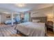 Comfortable bedroom featuring a bed, desk, window view, mirrored closet, and bedside table with a lamp at 8307 E Buena Terra Way, Scottsdale, AZ 85250
