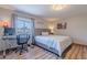 Cozy bedroom with a bed, a desk by the window, and soft natural light at 8307 E Buena Terra Way, Scottsdale, AZ 85250