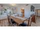 Dining area showcasing a large wooden table with chairs, built-in cabinets, and a view into the kitchen at 8307 E Buena Terra Way, Scottsdale, AZ 85250