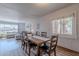 Bright dining area features a wooden table with chairs, connecting to a view of the living area at 8307 E Buena Terra Way, Scottsdale, AZ 85250