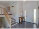 Welcoming foyer with high ceilings, wood flooring, and a staircase with wood banister at 8307 E Buena Terra Way, Scottsdale, AZ 85250