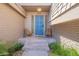 Inviting entryway with a blue front door, decorative sidelights, and cozy seating at 8307 E Buena Terra Way, Scottsdale, AZ 85250