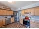 Bright kitchen featuring stainless steel appliances, wood cabinetry and vinyl plank flooring at 8307 E Buena Terra Way, Scottsdale, AZ 85250