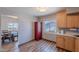 Kitchen with wood cabinets, wood-look floors, bright light and view to the dining room at 8307 E Buena Terra Way, Scottsdale, AZ 85250