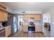 Bright kitchen featuring stainless steel appliances, wood cabinetry and vinyl plank flooring at 8307 E Buena Terra Way, Scottsdale, AZ 85250