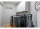 Functional laundry room with a modern washer and dryer, cabinets, and water heater at 8307 E Buena Terra Way, Scottsdale, AZ 85250