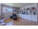 Inviting living room featuring custom built-ins, lots of light, and wood flooring at 8307 E Buena Terra Way, Scottsdale, AZ 85250
