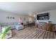 Spacious open living room with cozy sofa, media cabinet, and dining area at 8307 E Buena Terra Way, Scottsdale, AZ 85250
