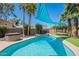 Relaxing backyard pool area, featuring shade sails, lush landscaping, and a spa, ideal for enjoying outdoor living at 8307 E Buena Terra Way, Scottsdale, AZ 85250
