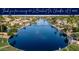Scenic aerial view of waterfront homes and landscaping along a wide canal with water fountain and boating docks at 835 W Beechnut Dr, Chandler, AZ 85248