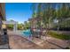 Outdoor patio area features a dining set under an umbrella and a lush yard with a pool at 835 W Beechnut Dr, Chandler, AZ 85248