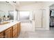 Bright bathroom featuring double sinks, a tub with mosaic tile accents, and a glass-enclosed shower at 835 W Beechnut Dr, Chandler, AZ 85248