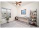 Multi-purpose room with a massage table, shelving, and a ceiling fan at 835 W Beechnut Dr, Chandler, AZ 85248