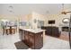 Open kitchen layout with granite island, stainless steel sink, and tile flooring at 835 W Beechnut Dr, Chandler, AZ 85248