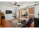 Comfortable living room features a sliding barn door, wood floors, and a ceiling fan at 835 W Beechnut Dr, Chandler, AZ 85248