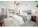 Tranquil main bedroom with plush bedding, ceiling fan, and a large window at 835 W Beechnut Dr, Chandler, AZ 85248