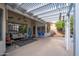 Covered patio with comfortable seating area, ceiling fan, and views of the green, landscaped backyard at 835 W Beechnut Dr, Chandler, AZ 85248