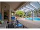 Covered patio with a seating area, a view of the pool, and shaded landscaping at 835 W Beechnut Dr, Chandler, AZ 85248